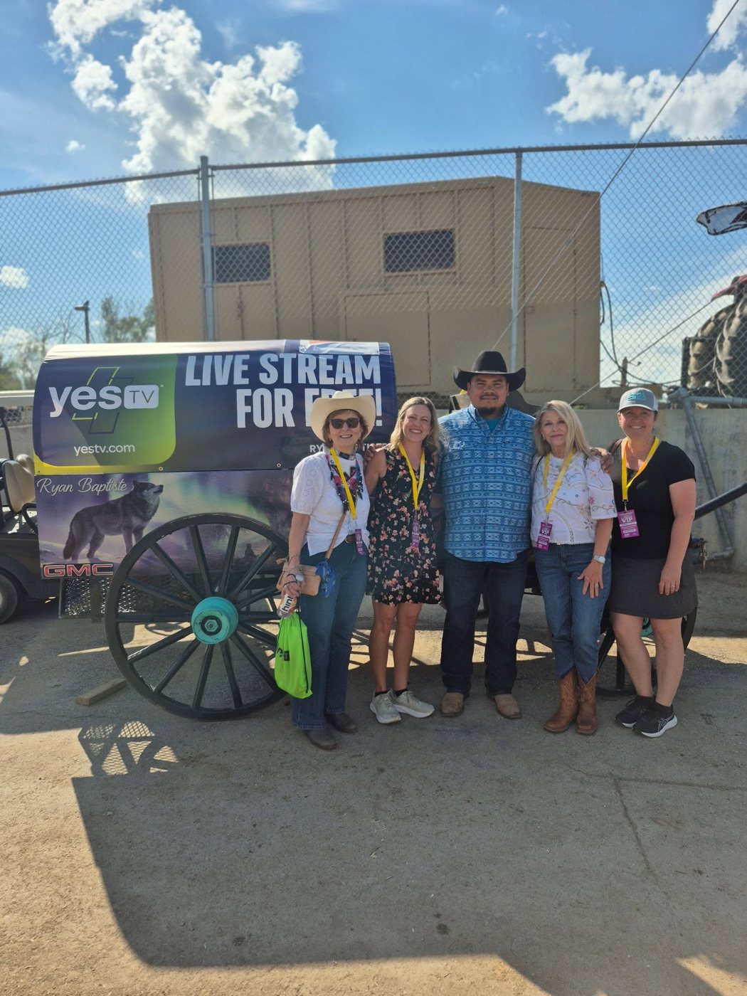 Valerie with friends in front of a YES TV covered wagon